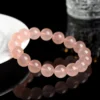 Auracharming Grapefruit Rose Quartz Bracelet Right Side Lighting Showing Greasy Luster