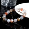 Overhead view of Auracharming Moonstone Bracelet in a marble bowl