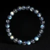 Overhead view of Auracharming Gray Moonstone Bracelet in a crystal bowl