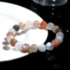 Overhead view of Auracharming Moonstone Bracelet in a marble bowl