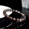 Overhead view of Auracharming Skeleton Bracelet in a geode bowl