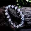 Auracharming White Phantom Pyramid Bracelet on Raw Wood Stump Showcasing Natural Energy